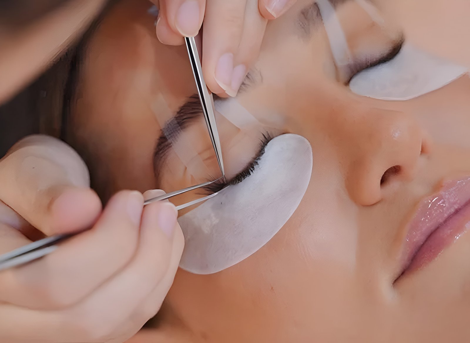 Woman receiving an eyelash extension treatment