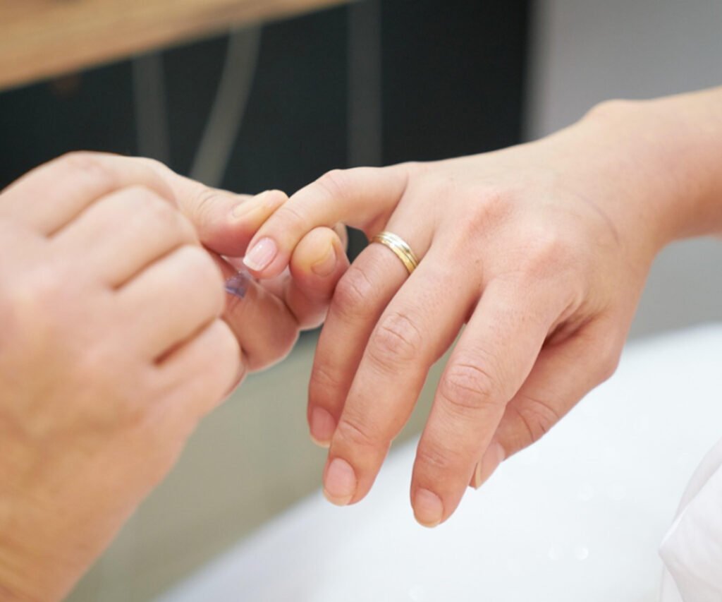 A nail technician performing a nail care treatment in Dubai, focusing on maintaining healthy nails during seasonal changes.