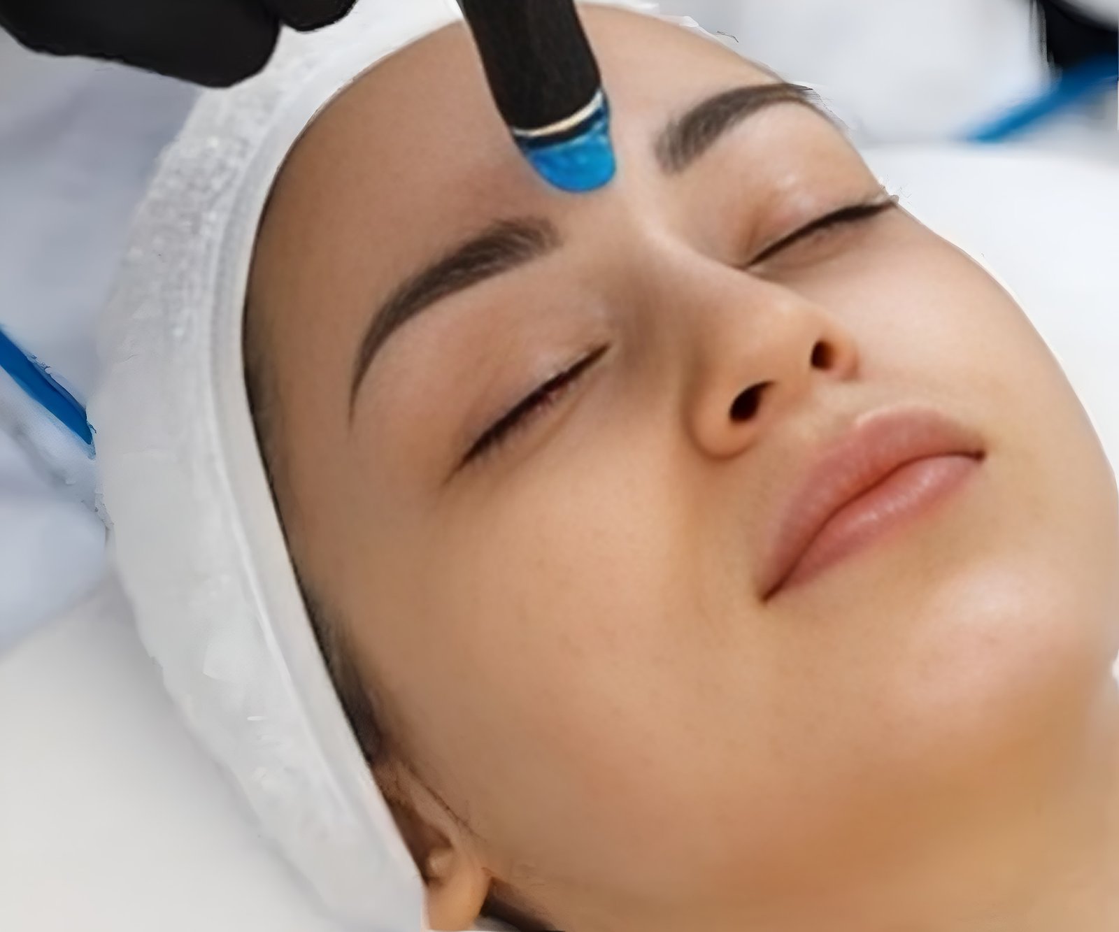 Close-up of a woman receiving a professional facial treatment.